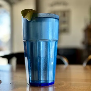 Plastic blue cup with tap water