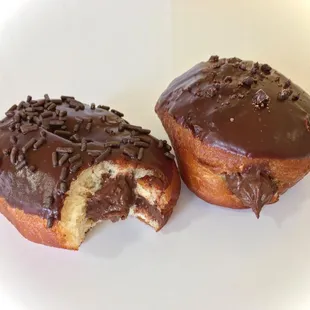 a chocolate frosted donut with a bite taken out of it