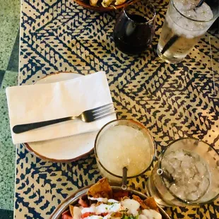 a plate of nachos and a glass of water