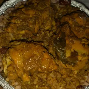 Bone in chicken curry with peas and rice.