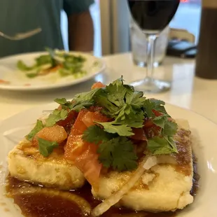 a plate of food and a glass of wine