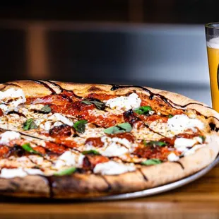 a pizza and a glass of beer