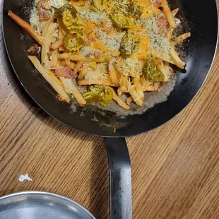 Loaded fries    Nice touch serving the loaded fries in a hot skillet!