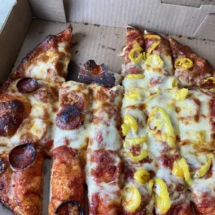 One pepperoni on some pieces, puddled cheese in middle, no cheese on some pieces and partially burnt