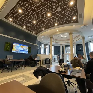 people sitting at tables with laptops