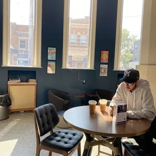 a man sitting at a table reading a book