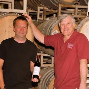two men in a wine cellar