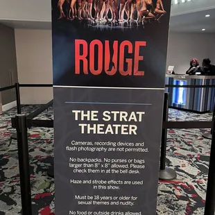 a sign at the entrance of a theater