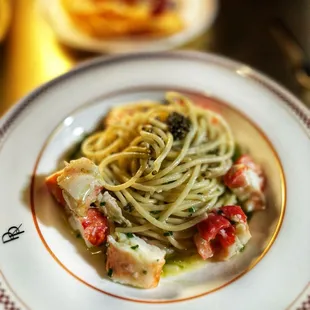 a plate of pasta with chicken and vegetables
