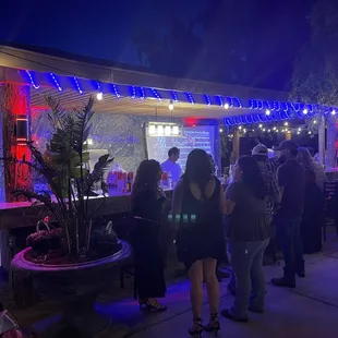 a group of people standing outside at night