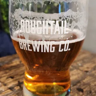 a glass of beer on a table