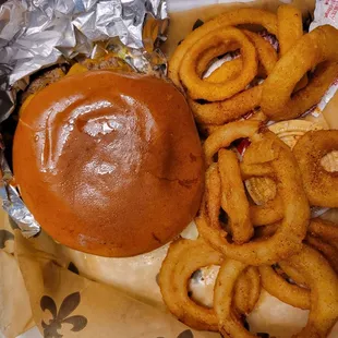 Jalepeno burger with cheddar cheese and onion rings.