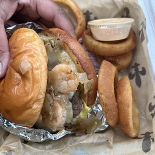 Shrimp burger and onion rings. Always hot fresh and right on time!