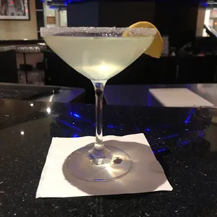 a martini with a slice of lemon on the rim