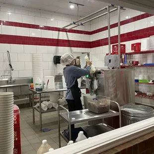 a woman preparing food in a kitchen