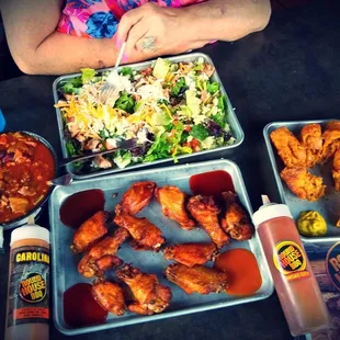 a woman sitting at a table full of food