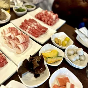 a variety of meats on plates