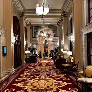 a red carpeted hallway in a hotel