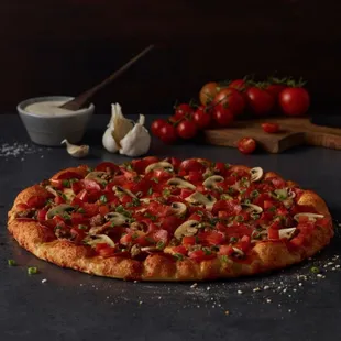 a pizza with tomatoes, onions, and cheese