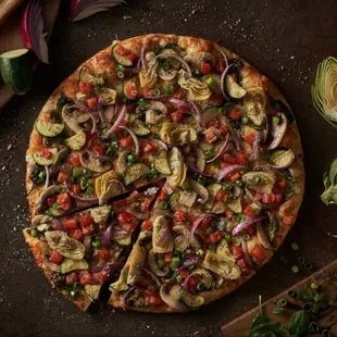 a whole pizza with vegetables on it