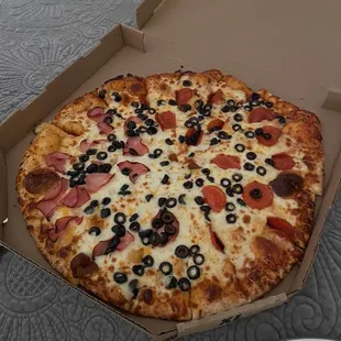Extra large pizza with ham, pepperoni, olives and, extra cheese.
