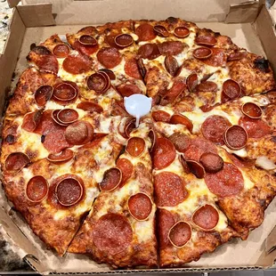 a pepperoni pizza in a cardboard box