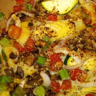 Gourmet veggie pizza, after a lot of onion was removed. It had a token piece of zucchini. The dark dots and patches are the seasoning,