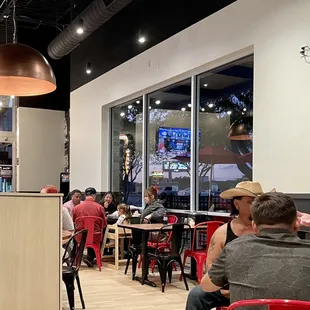 people sitting at tables in a restaurant