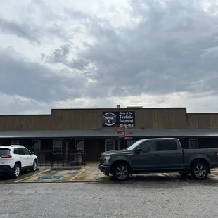 two trucks parked in front of the building