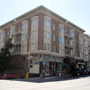 a large brick building on a street corner