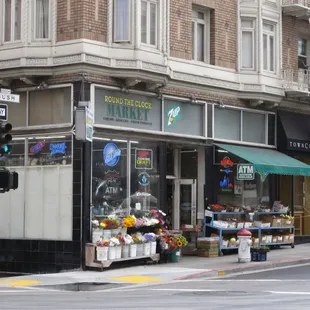a flower shop on the corner of a street