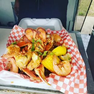 Lobster tail boil with Crab Leg cluster, shrimp, potatoes and corn on the cob