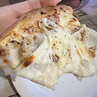 Thin crust chicken Alfredo pizza. Cheese is super stringy when hot. Yum!