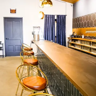 a row of stools at the bar