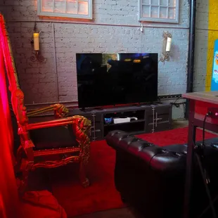 a living room with a couch, chair, and television