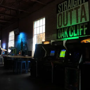 a row of arcade machines in a dark room