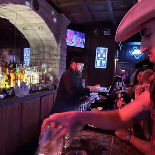 a bartender pouring a drink