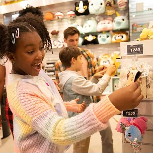 a young girl shopping in a toy store