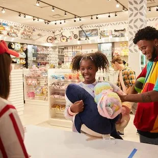 a man handing a girl a stuffed animal