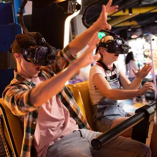 a man and a woman wearing virtual reality headsets