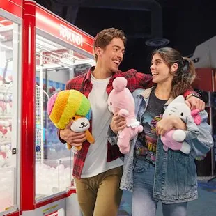 a man and a woman standing in front of a vending machine
