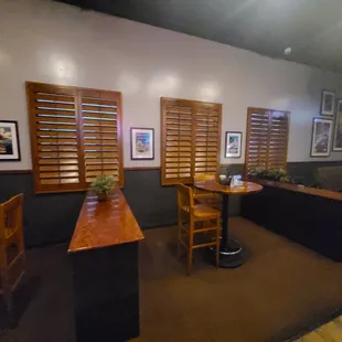 the interior of a restaurant with tables and chairs