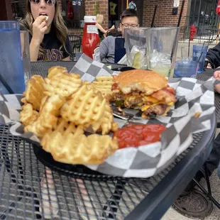 a woman sitting at a table with a plate of food