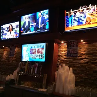 a bar with a variety of televisions