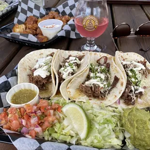 Shredded brisket tacos on flour tortillas, pretzel bites and hard seltzer in the back!