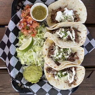 Shredded Brisket Tacos on Flour Tortilla.