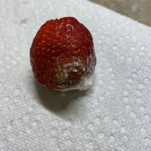 a strawberry on a napkin