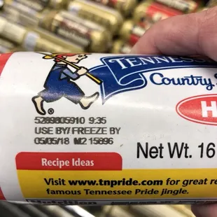 a hand holding a can of ice cream