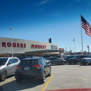 cars in parking lot with american flag