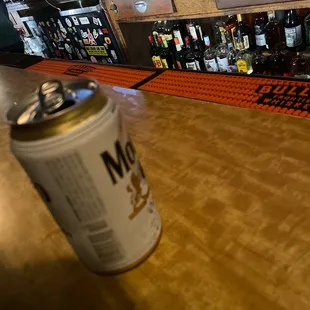 a can of beer on a bar counter